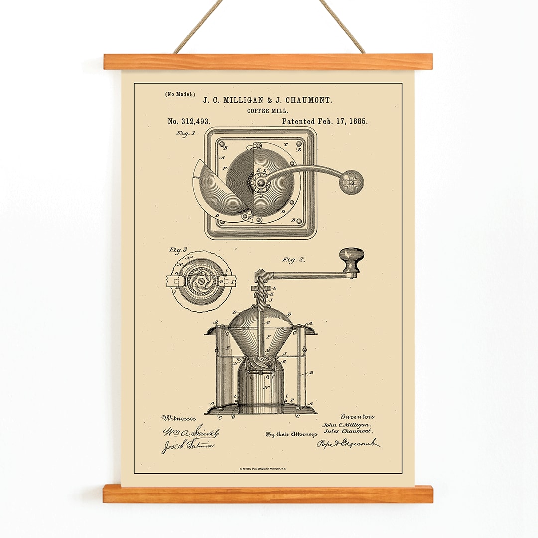 Detailed black and white illustration and patent poster of a mechanical coffee grinder by J C Milligan titled Coffee Mill showing detailed components, with wooden magnetic frame on white background