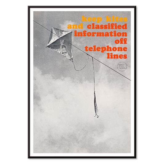 Black and white photo and poster of a kite tangled on a telephone line with bold warning text Keep kites and classified information off telephone lines, with black aluminium frame on white background