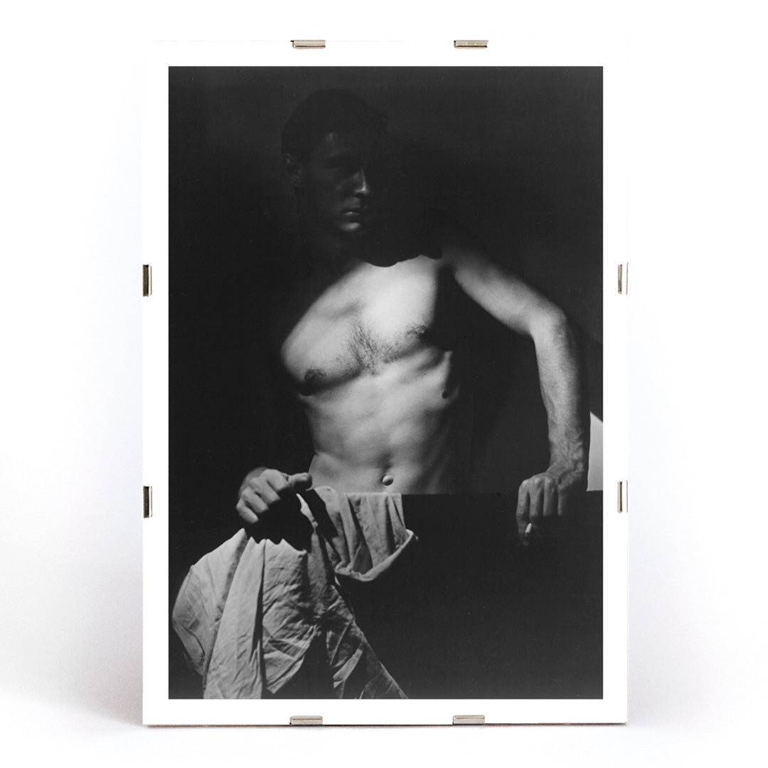 Shirtless man holding towel in dramatic lighting Max After Surfing by Olive Cotton wall art photography poster, framed and displayed in modern living room decor