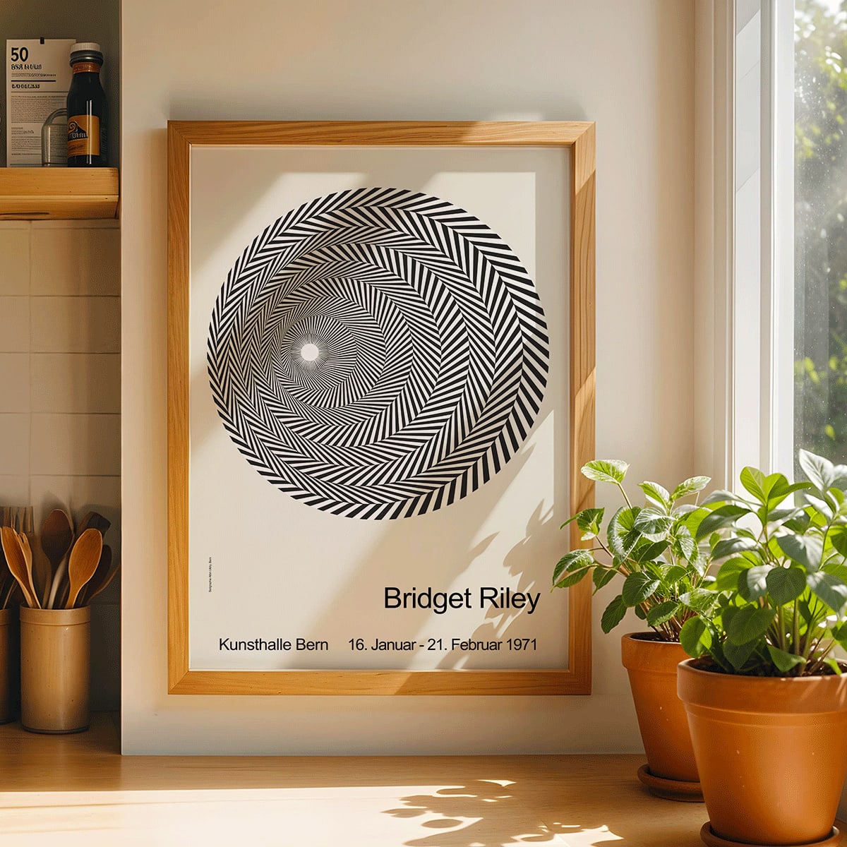 Bridget Riley Blaze Exhibition Poster featuring hypnotic black and white spiral geometric design on light background, framed and displayed in modern living room decor