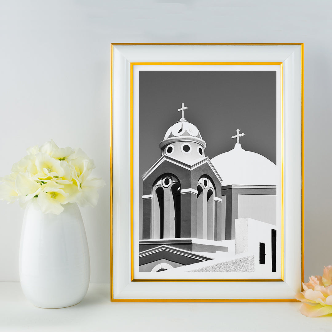 Black and white artwork of a traditional church dome and cross in Santorini Greece by artist Santorini Greece poster featuring classic architecture against a clear sky, framed and displayed in home decor