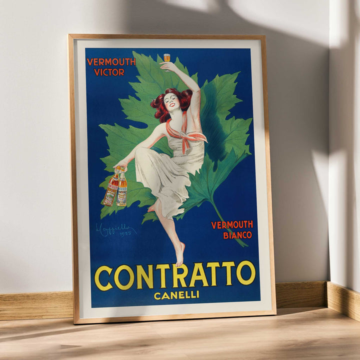 Leonetto Cappiello Contratto Canelli poster of a woman raising a glass above vermouth bottles with green vine leaves, framed and displayed in modern living room decor