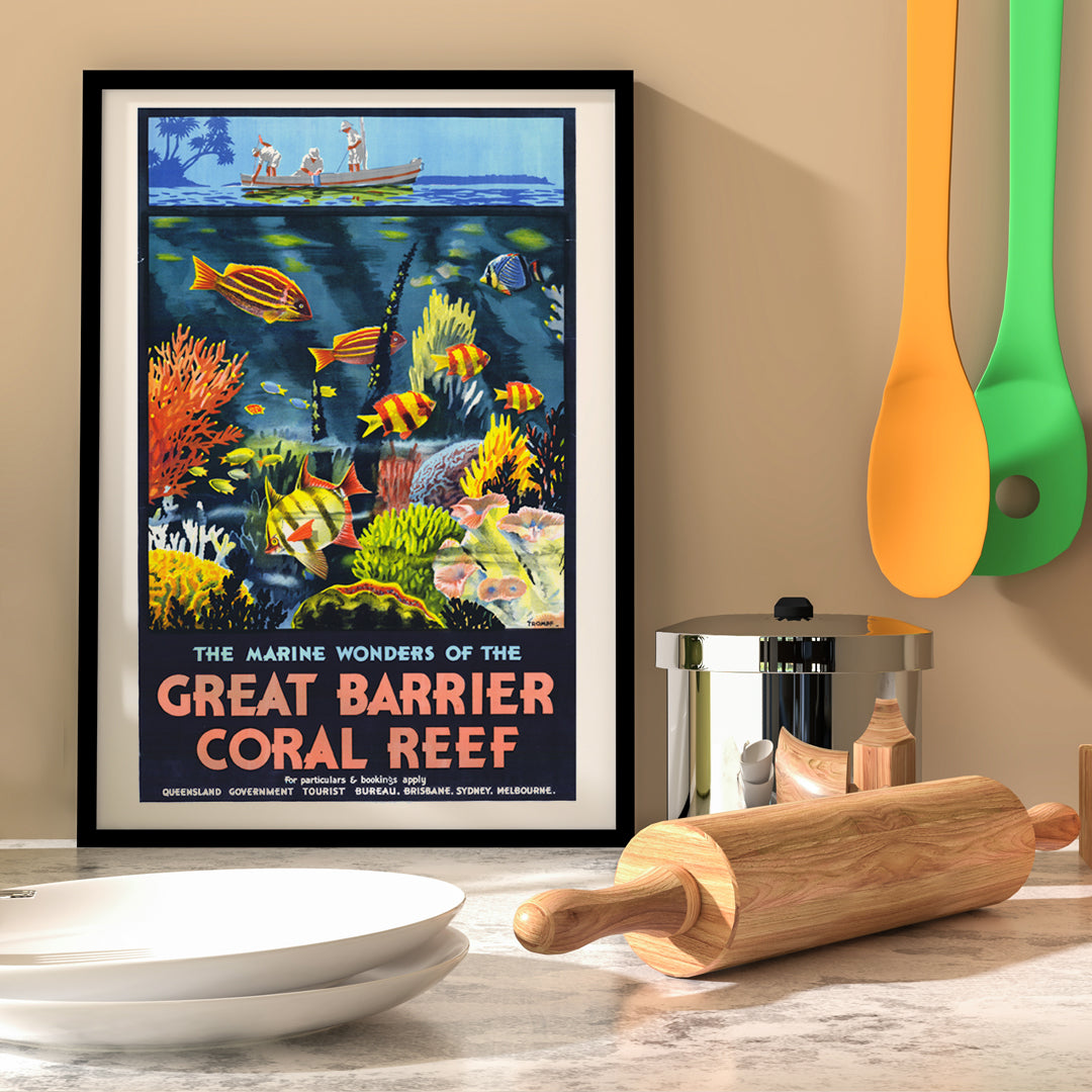 Colorful coral reef and tropical fish with people in a boat above artwork The Marine Wonders of the Great Barrier Coral Reef by Percival Albert Trompf, framed and displayed in home decor