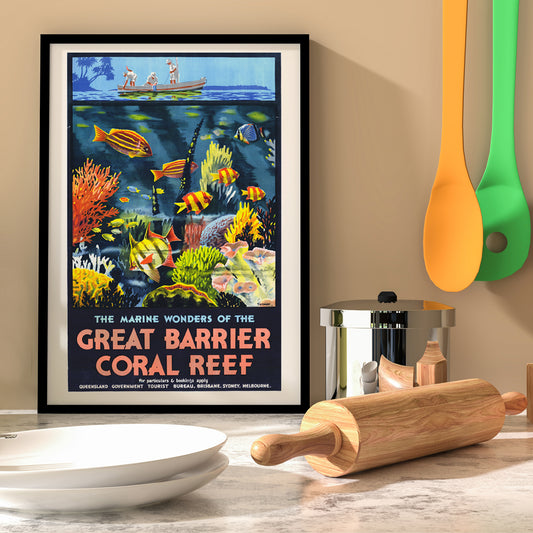 Colorful coral reef and tropical fish with people in a boat above artwork The Marine Wonders of the Great Barrier Coral Reef by Percival Albert Trompf, framed and displayed in home decor