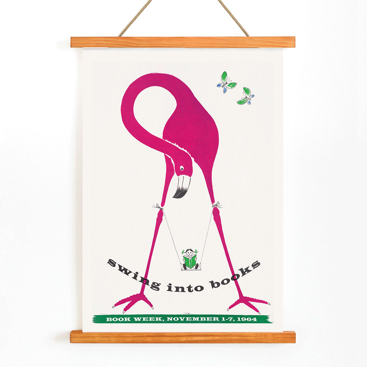Pink flamingo holding a swinging book with butterflies and a monkey art poster titled Swing into Books, with wooden magnetic frame on white background
