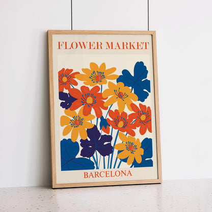 Vibrant orange yellow and blue flower artwork poster titled Flower Market Barcelona by artist Moryarty with text displayed at top and bottom, framed and displayed in home decor
