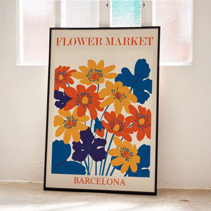 Vibrant orange yellow and blue flower artwork poster titled Flower Market Barcelona by artist Moryarty with text displayed at top and bottom, framed and displayed in modern living room decor