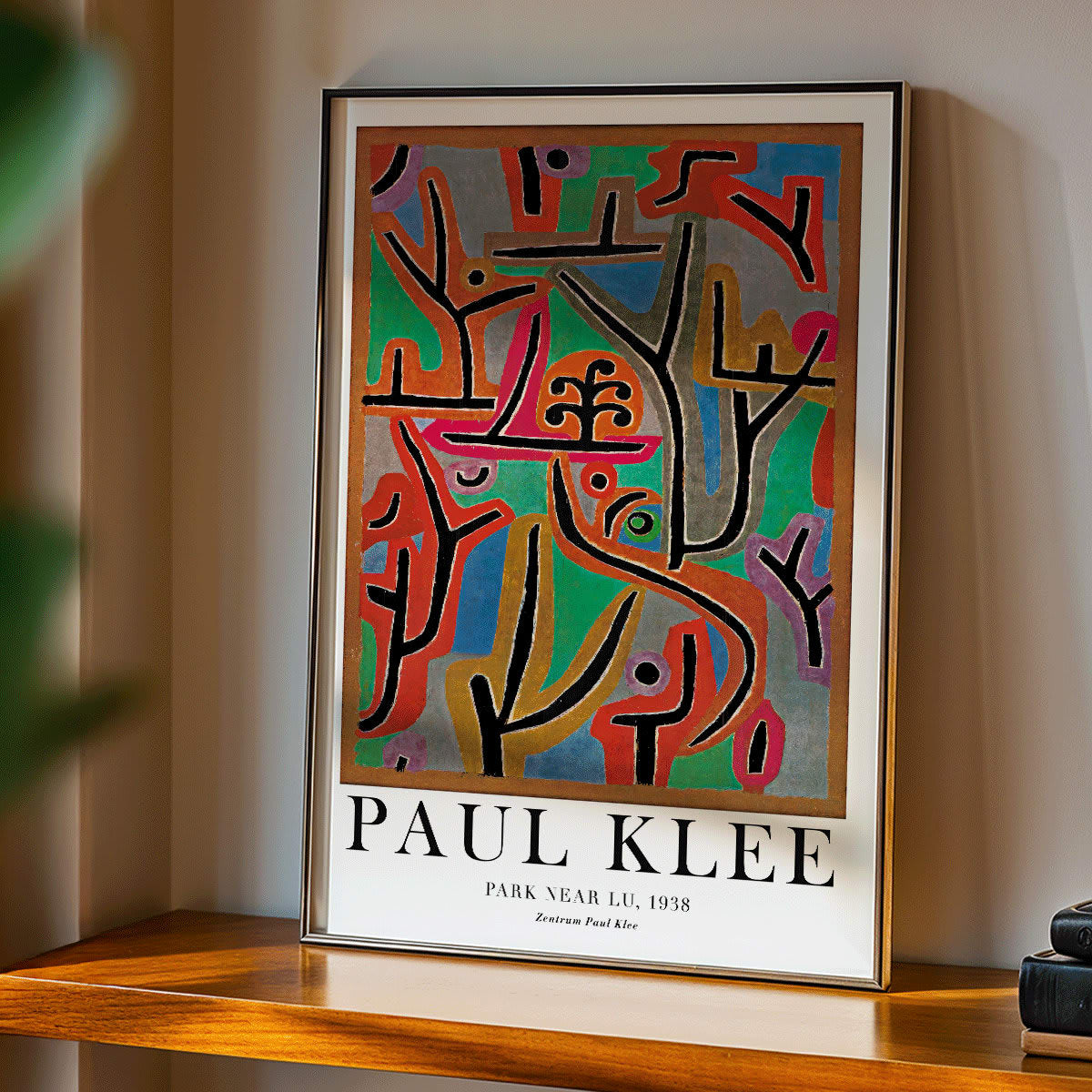 Exhibition poster of Park Near Lu by Paul Klee featuring vibrant abstract shapes and bold lines in diverse colors, framed and displayed in home decor