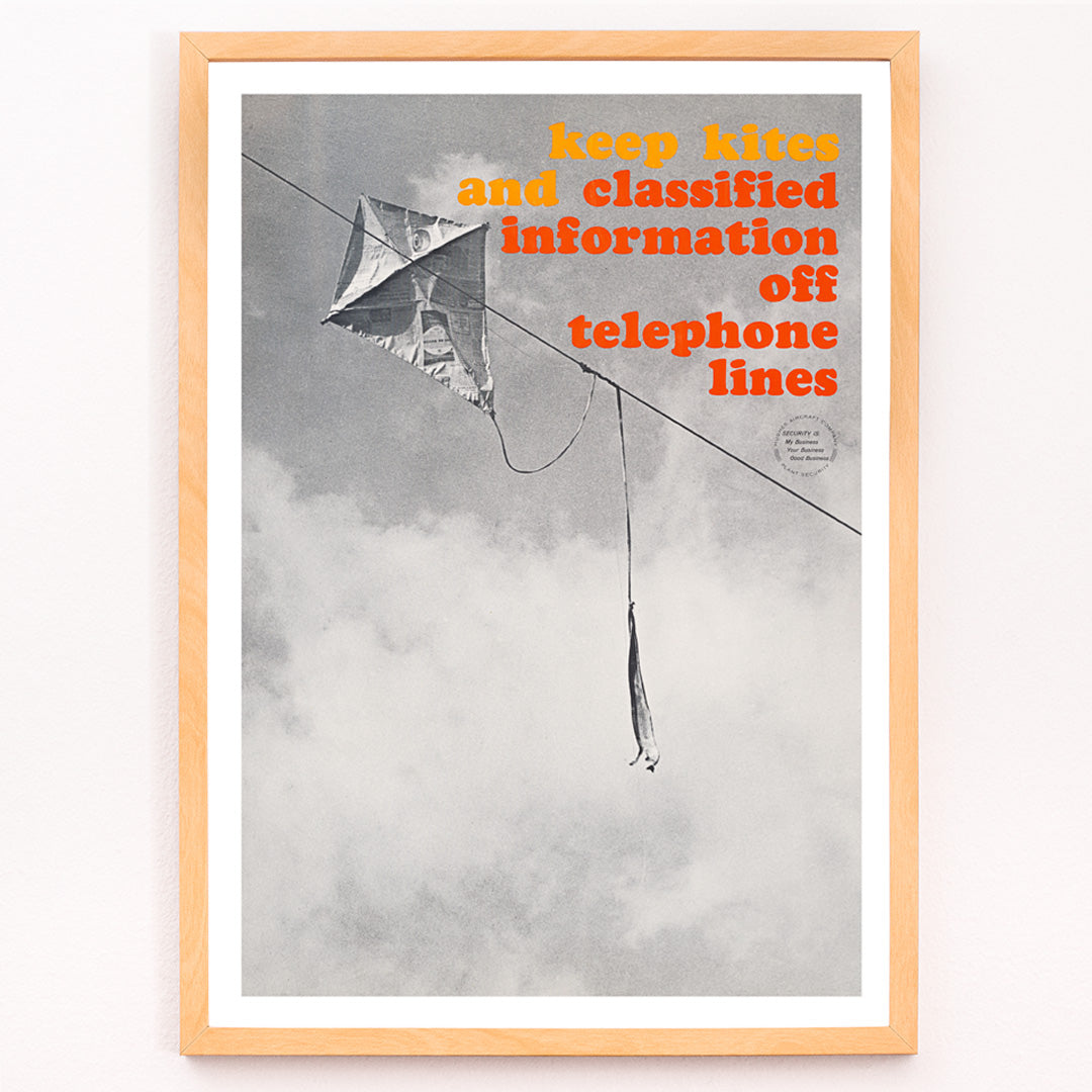 Closeup detail of Black and white photo and poster of a kite tangled on a telephone line with bold warning text Keep kites and classified information off telephone lines
