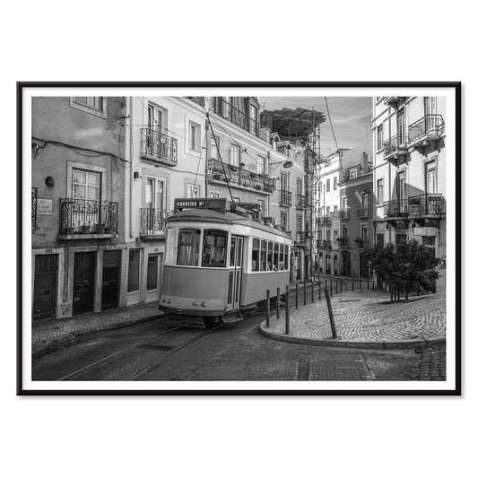 Lisbon Tramway 28 Black and White historic tram navigating cobblestone streets in Lisbon street scene poster, with black aluminium frame on white background