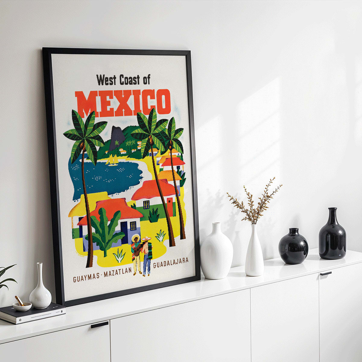 Colorful vintage travel poster of the West Coast of Mexico by Ray Bethers with palm trees and vibrant colorful houses, framed and displayed in modern living room decor