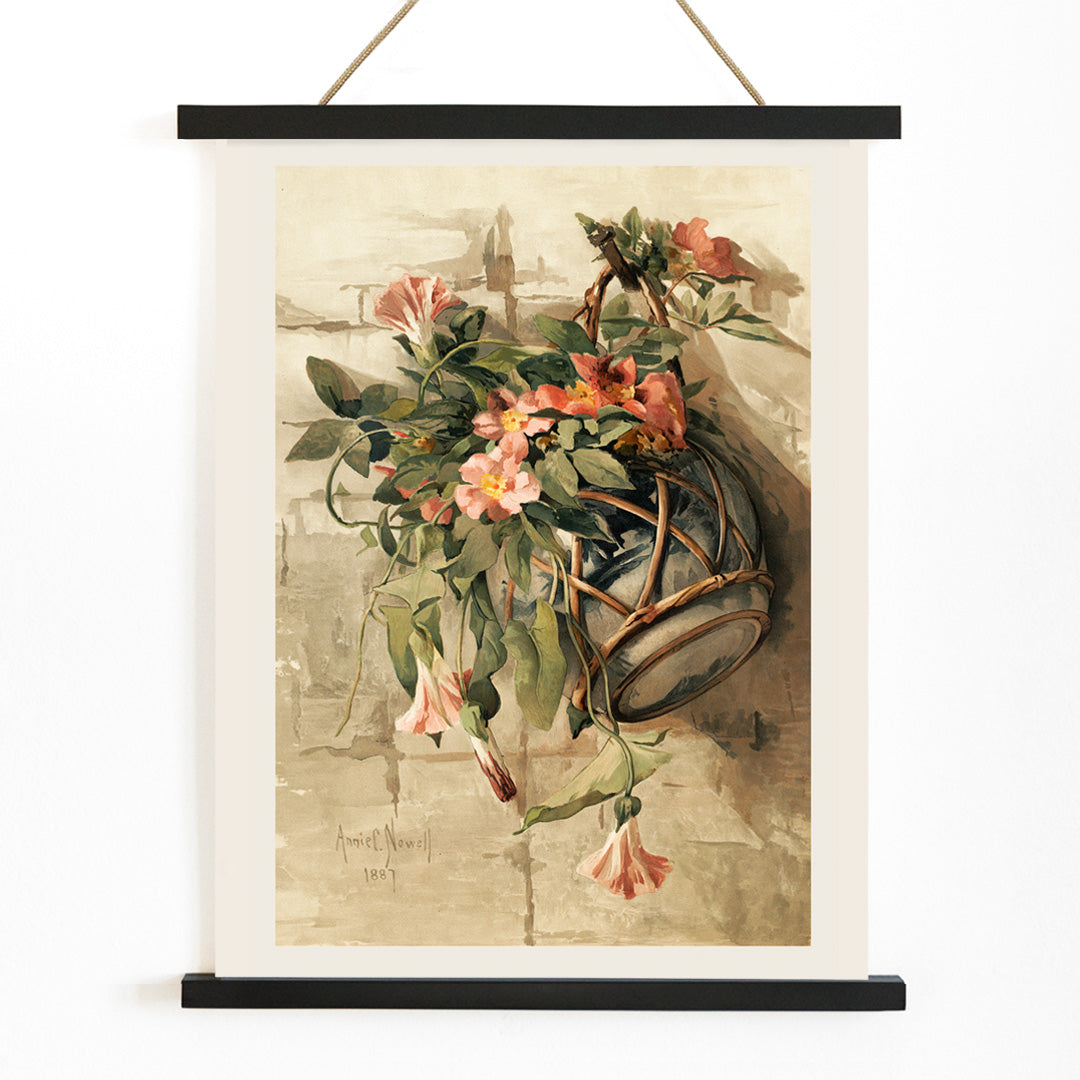 Pink flowers in a hanging vase still life painting by Annie Nowell featuring delicate blooms in a rustic container against a neutral background, with wooden magnetic frame on white background