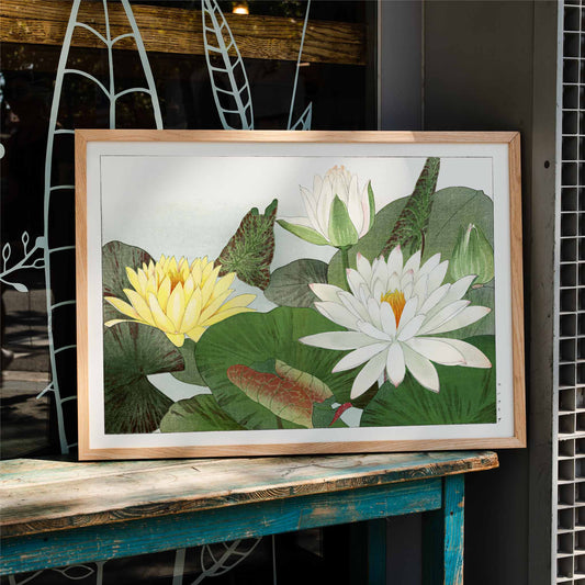 Illustration of yellow and white water lilies with lush green leaves from Nymphaea lotus by Tanigami Konan wall decor poster, framed and displayed in home decor