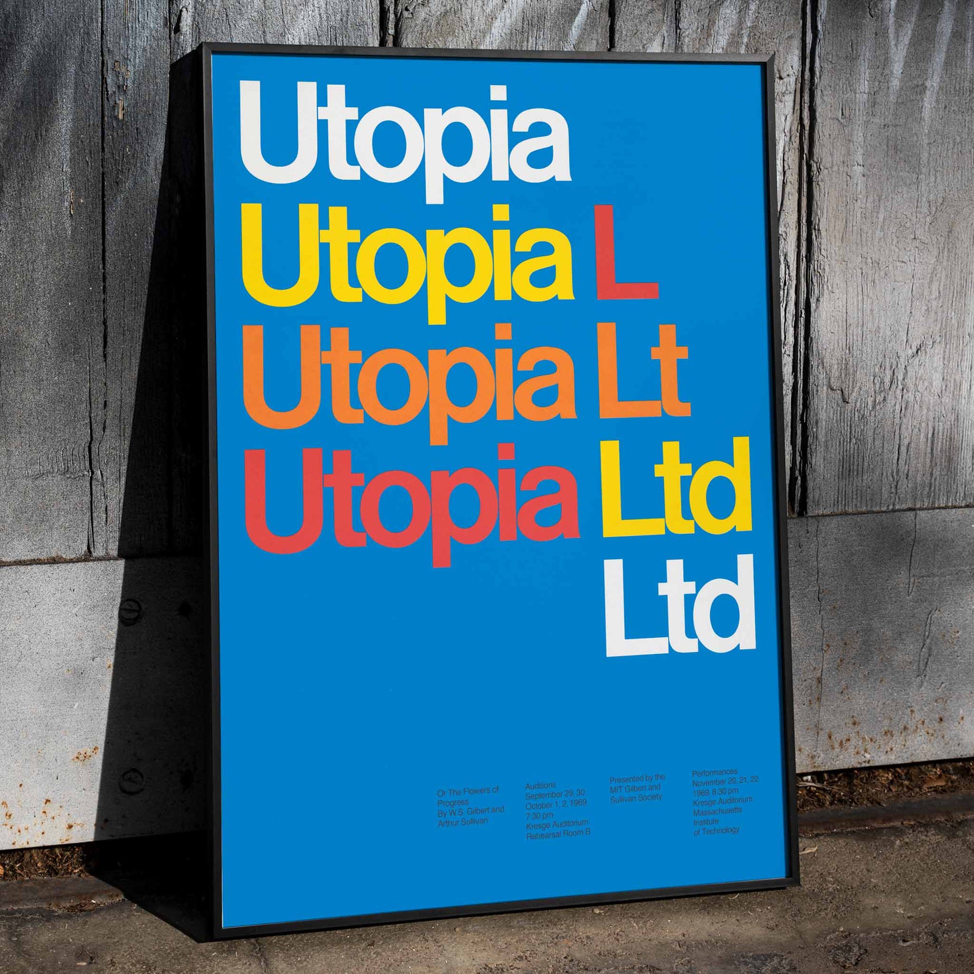 Colorful typographic poster of the words Utopia Ltd on blue background by artist Dietmar Winkler artwork, framed and displayed in home decor