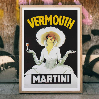 Vermouth Martini by Marcello Dudovich vintage poster art featuring an elegant woman in white holding a glass against a black background, framed and displayed in home decor