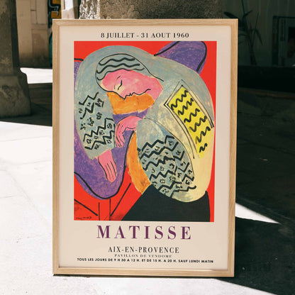 Henri Matisse The Dream exhibition poster at Aix en Provence featuring colorful abstract design with reclining figure, framed and displayed in home decor