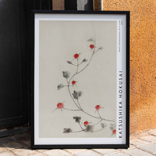 Small Red Blossoms on a Vine artwork by Katsushika Hokusai featuring delicate red flowers and green leaves on a light background, framed and displayed in home decor