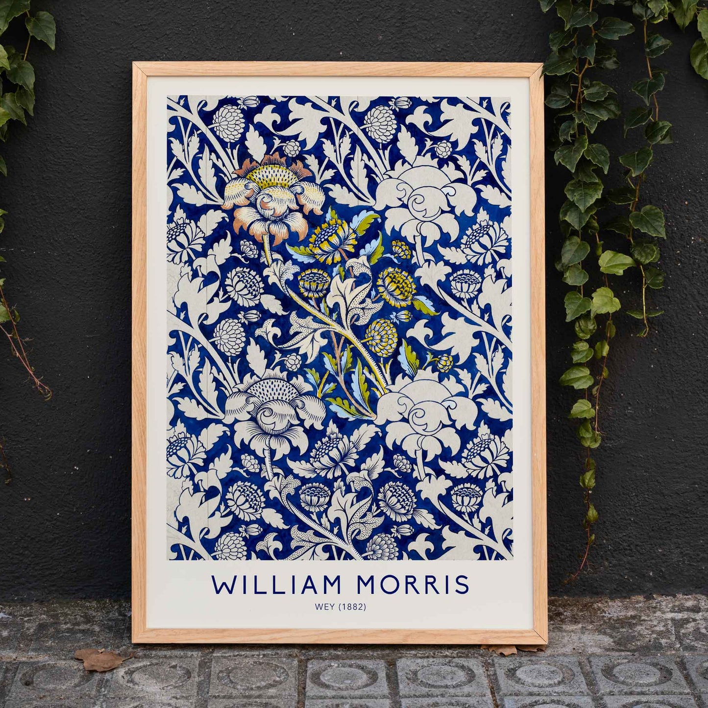 Floral fabric pattern and watercolour poster with intricate blue and white design by William Morris Wey, framed and displayed in home decor