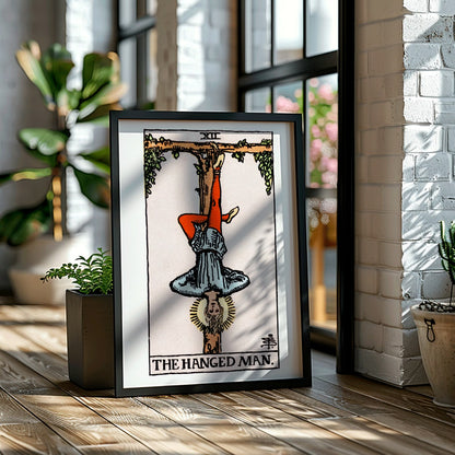 Hanged Man Tarot Card by Rider Waite, figure hanging upside down from wooden structure, mystical poster art, framed and displayed in home decor