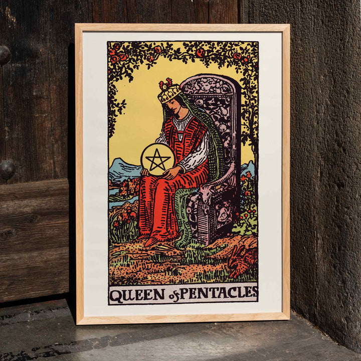 Queen of Pentacles tarot card poster by Pamela Colman Smith with crowned woman in red robes and pentacle, framed and displayed in home decor