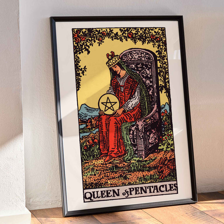 Queen of Pentacles tarot card poster by Pamela Colman Smith with crowned woman in red robes and pentacle, framed and displayed in modern living room decor