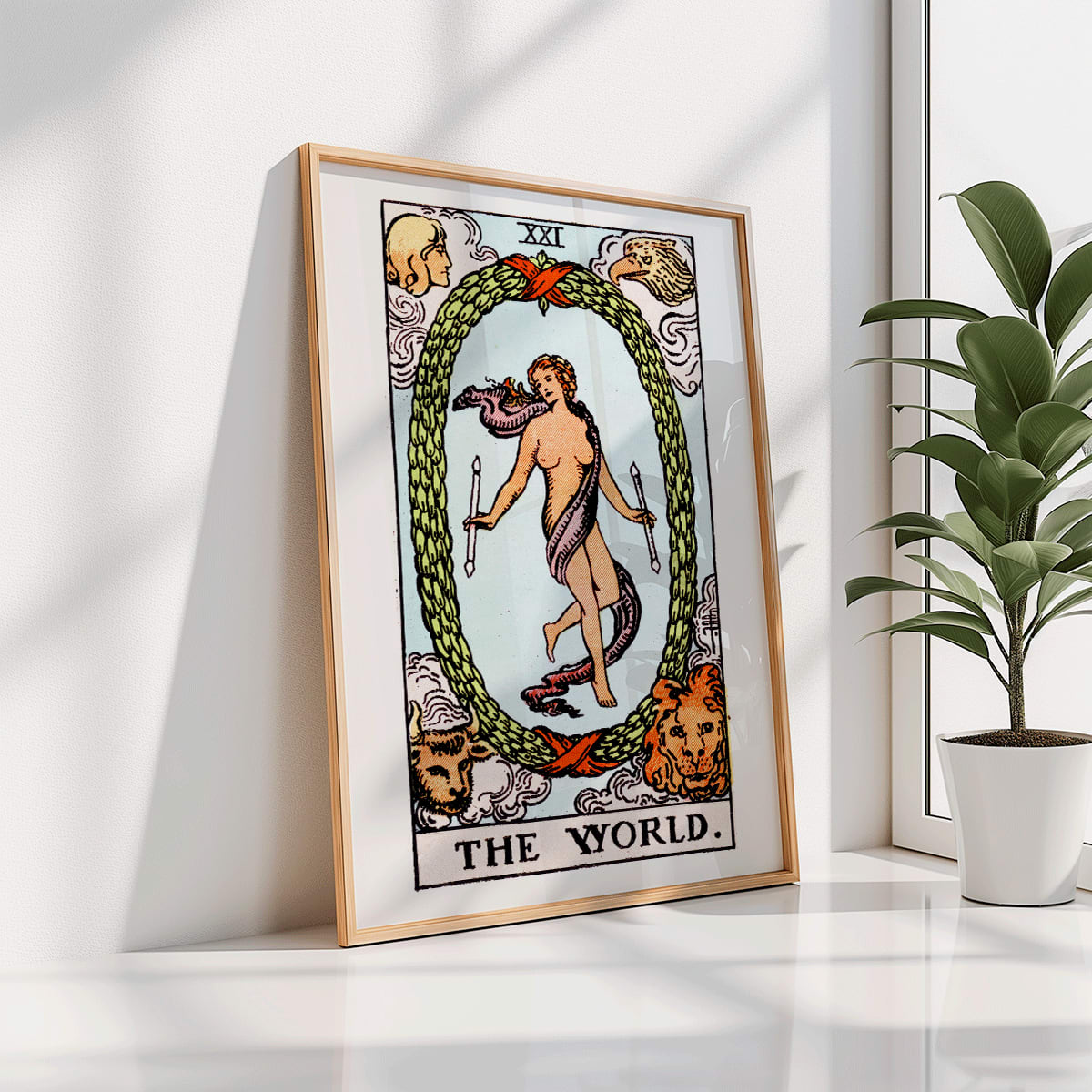 The World Tarot card by Rider Waite showing a central figure within an oval wreath surrounded by four figures representing the fixed signs, framed and displayed in home decor