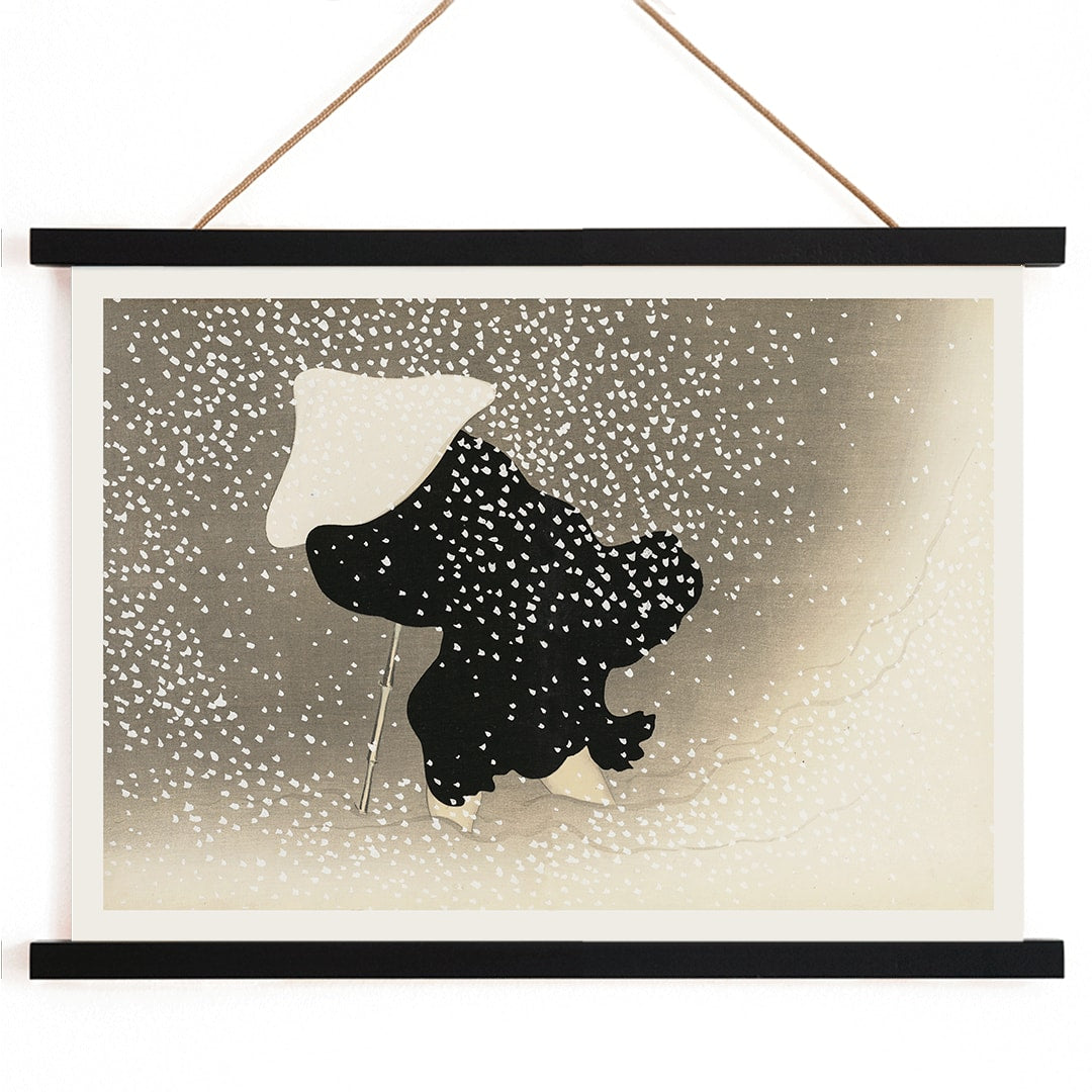 Poster of Tomoe no yuki by Kamisaka Sekka showing a snowy scene with a silhouette of a figure in dark attire under heavy snowfall wearing a white hat and holding a walking stick, with wooden magnetic frame on white background