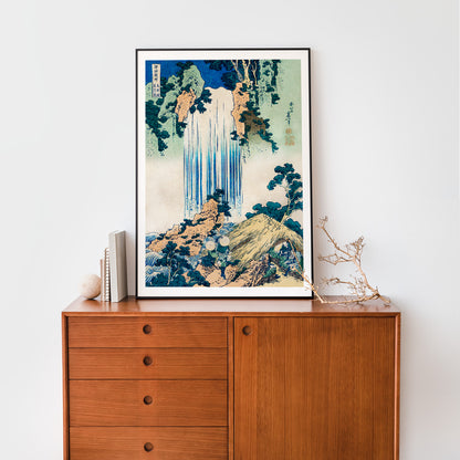 Yoro Waterfall in Mino Province by Katsushika Hokusai featuring lush greenery figures trees rocks and people in straw hats, framed and displayed in home decor