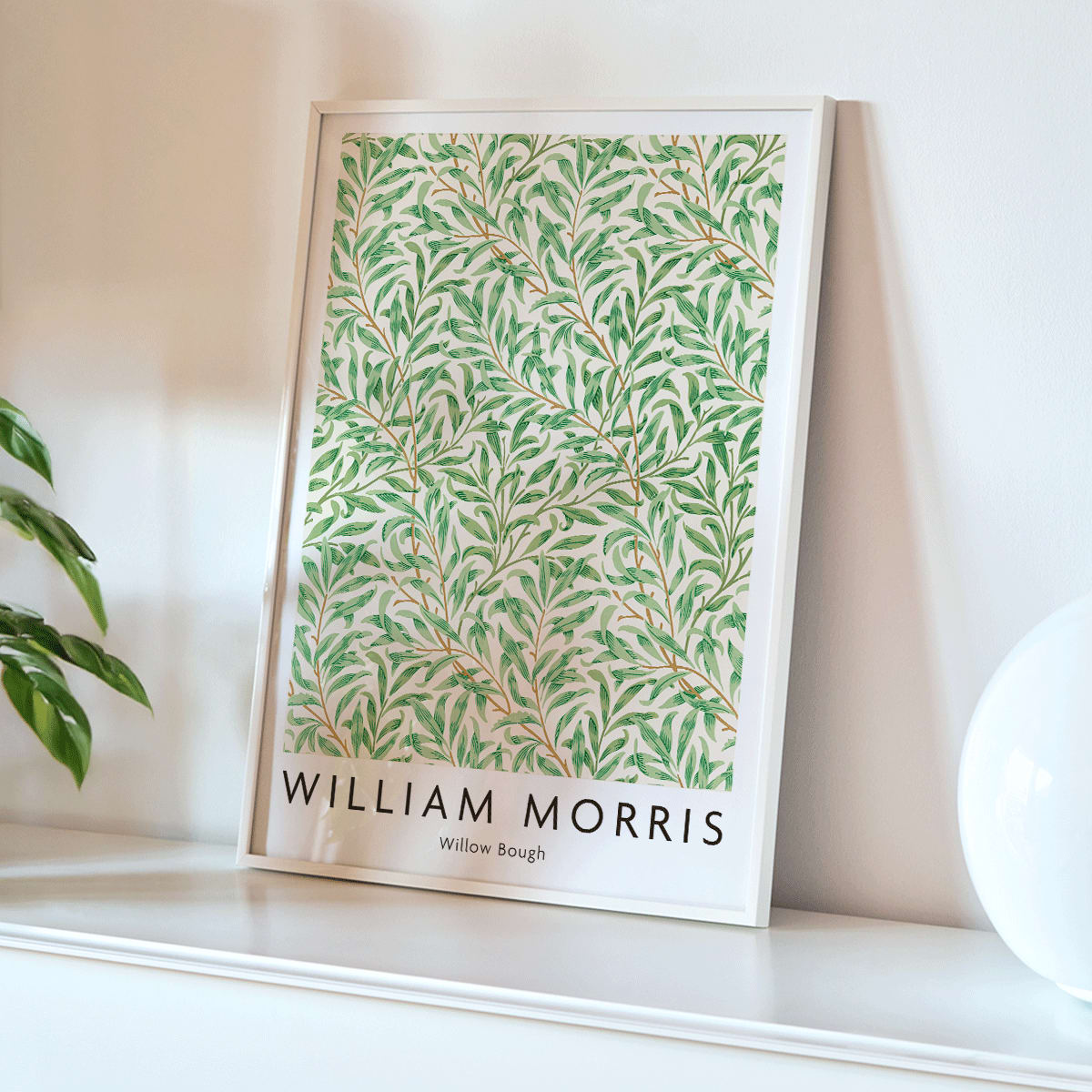 Willow Bough by William Morris leafy botanical pattern poster with intricate green willow branches and leaves on light background, framed and displayed in home decor