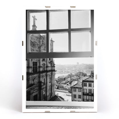 Black and white cityscape poster of Porto seen through a window from the artwork Porto from window, framed and displayed in modern living room decor